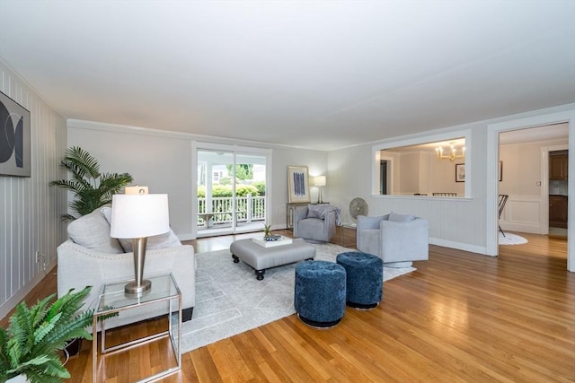 6 Gilbert Rd, Natick, MA 01760 - living room with wood finished floors, a chandelier, and a decorative wall