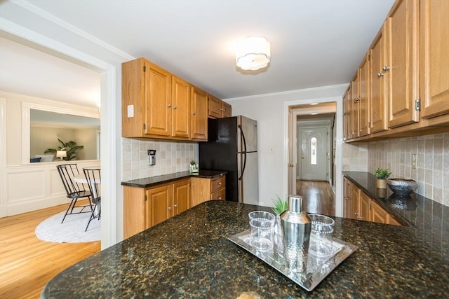 6 Gilbert Rd, Natick, MA 01760 - kitchen with freestanding refrigerator, wood finished floors, dark stone counters, ornamental molding, and decorative backsplash