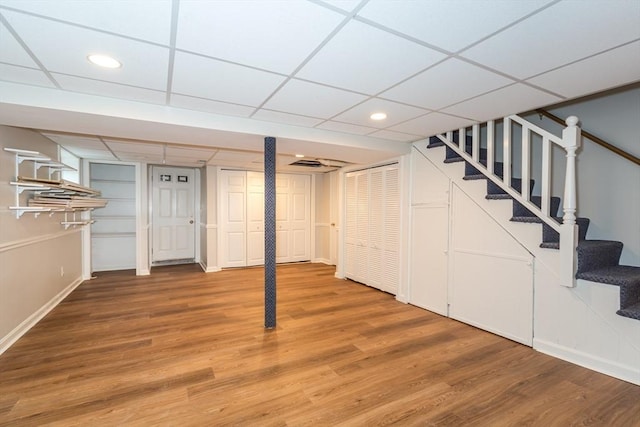 6 Gilbert Rd, Natick, MA 01760 - finished basement featuring stairs, light wood-style flooring, a drop ceiling, baseboards, and recessed lighting
