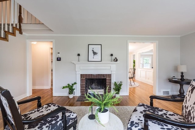 6 Gilbert Rd, Natick, MA 01760 - living area featuring wood finished floors, ornamental molding, a fireplace, baseboards, and stairs