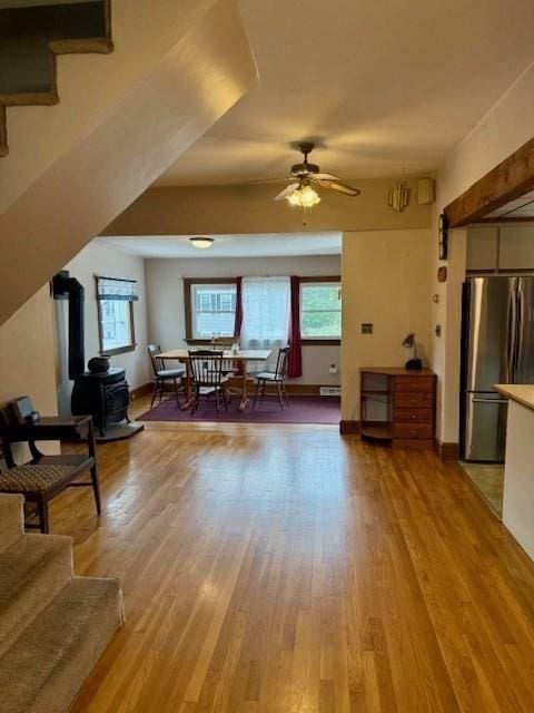 14 Pequot Rd, Weymouth, MA 02191 - living area featuring a wood stove, plenty of natural light, a ceiling fan, and light wood-type flooring