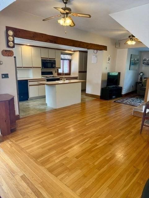14 Pequot Rd, Weymouth, MA 02191 - kitchen with black microwave, ceiling fan, open floor plan, and light wood-style flooring