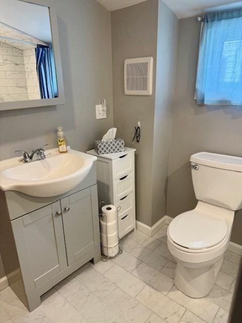 14 Pequot Rd, Weymouth, MA 02191 - bathroom with marble look tile flooring, toilet, baseboards, and vanity