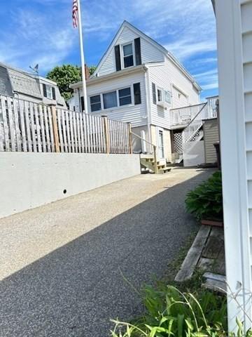 14 Pequot Rd, Weymouth, MA 02191 - rear view of house with stairway and fence