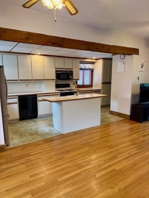 14 Pequot Rd, Weymouth, MA 02191 - kitchen with black appliances, light wood-type flooring, light countertops, and ceiling fan