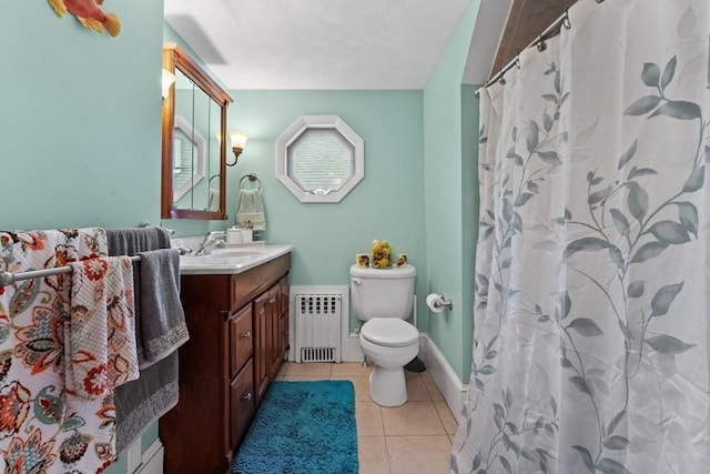 bathroom with toilet, vanity, walk in shower, tile patterned floors, and radiator