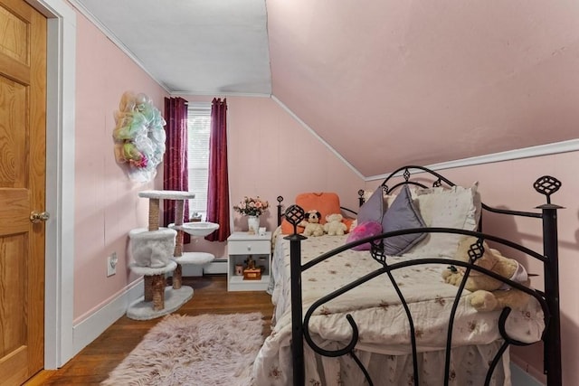 bedroom featuring baseboard heating, lofted ceiling, and hardwood / wood-style floors