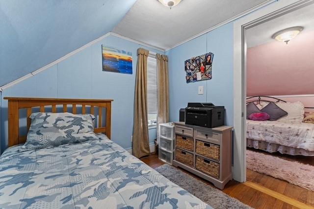 bedroom with lofted ceiling and hardwood / wood-style flooring