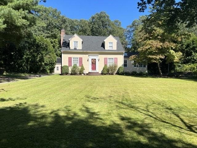 24 Congamond Rd, Southwick, MA 01077 - cape cod-style house with a chimney and a front lawn