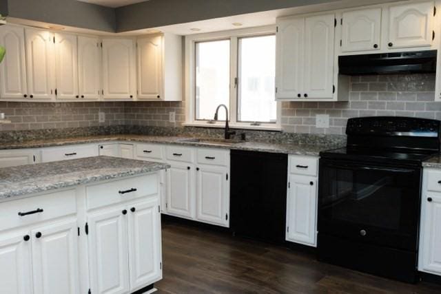 24 Congamond Rd, Southwick, MA 01077 - kitchen featuring dark wood finished floors, under cabinet range hood, a sink, light stone counters, and black appliances