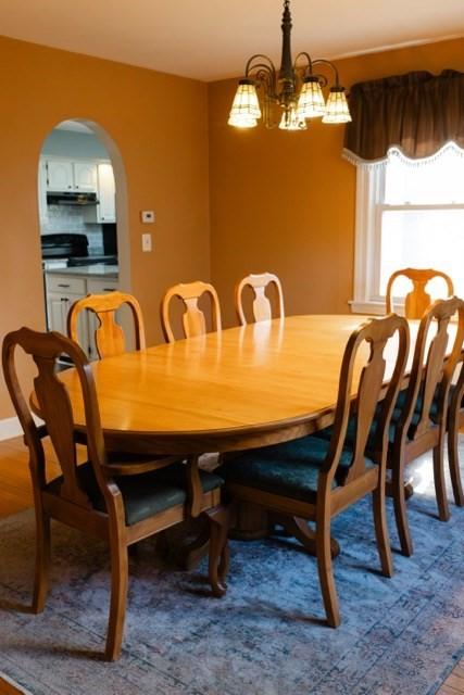 24 Congamond Rd, Southwick, MA 01077 - dining space featuring arched walkways and an inviting chandelier