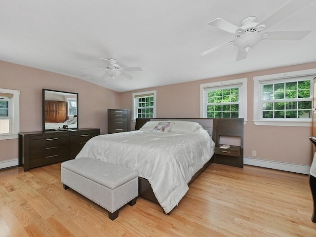 bedroom with ceiling fan, light hardwood / wood-style flooring, and a baseboard radiator