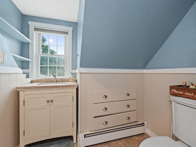 bathroom featuring vanity, vaulted ceiling, toilet, and a baseboard radiator