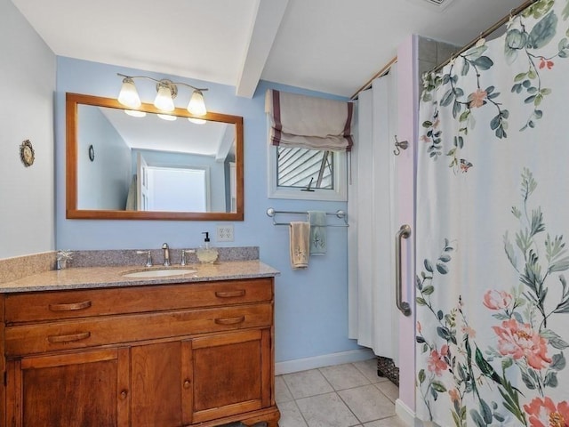 bathroom with tile patterned floors, vanity, and walk in shower