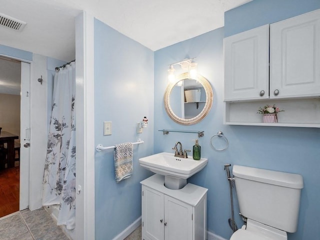 bathroom with tile patterned floors, vanity, a shower with shower curtain, and toilet