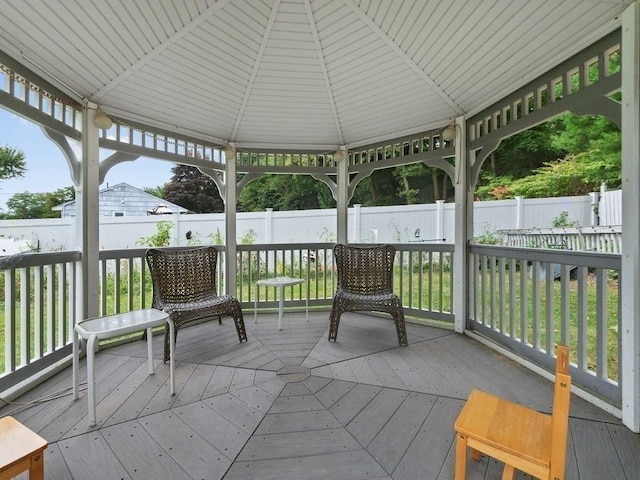 sunroom with plenty of natural light and lofted ceiling