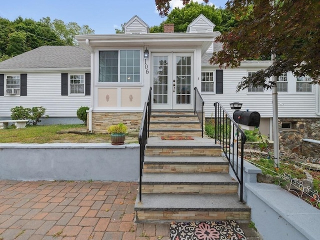 bungalow-style house featuring french doors