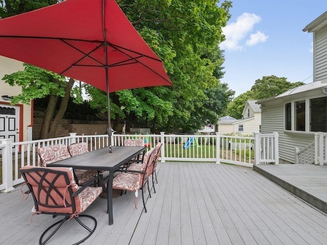 wooden deck featuring a playground