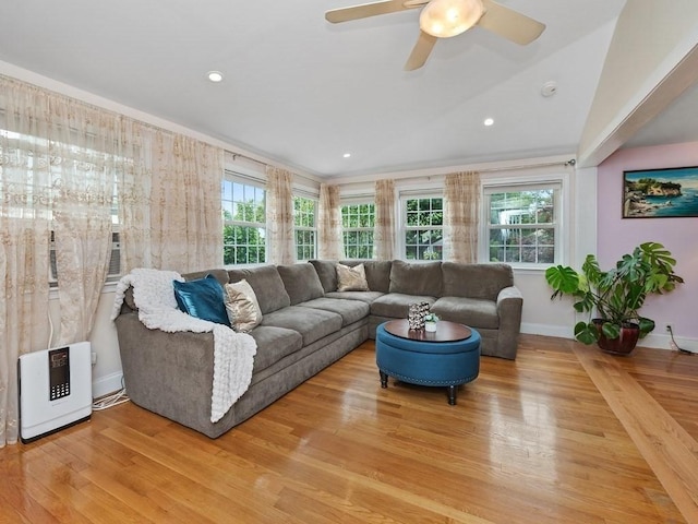 living room featuring ceiling fan, a healthy amount of sunlight, lofted ceiling, and light hardwood / wood-style floors