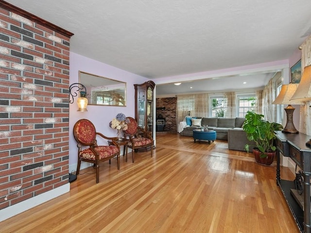 living room featuring light hardwood / wood-style floors and brick wall