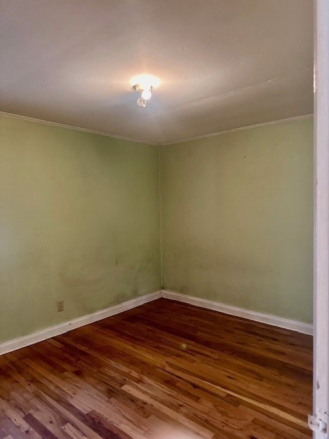 unfurnished room with hardwood / wood-style floors and ornamental molding