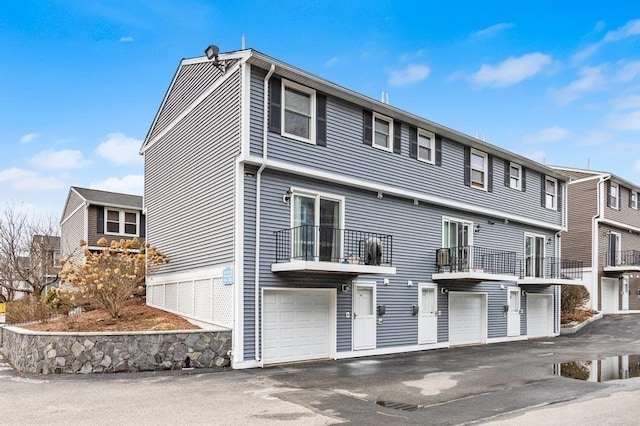 exterior space with a balcony and a garage