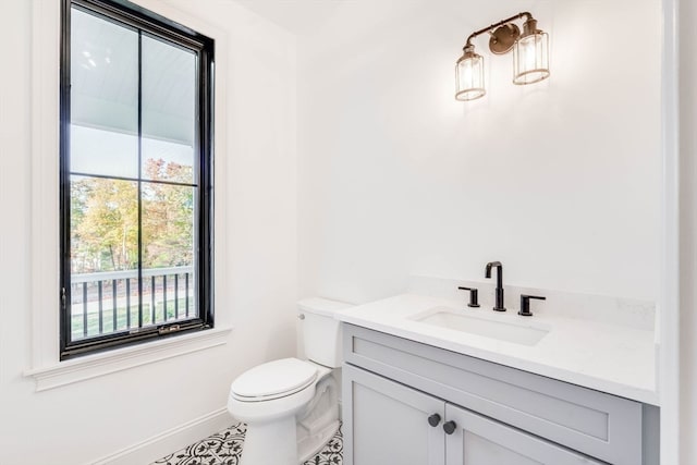 bathroom featuring vanity, toilet, and tile patterned flooring