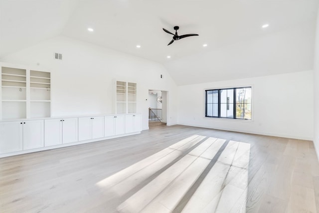 unfurnished living room featuring vaulted ceiling, light wood-type flooring, and ceiling fan