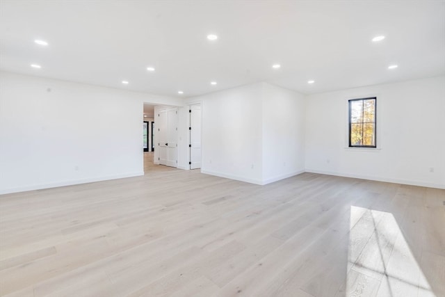 spare room with light hardwood / wood-style flooring