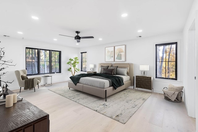 bedroom with light hardwood / wood-style flooring and ceiling fan