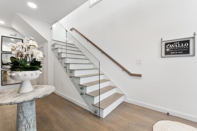 staircase with hardwood / wood-style floors