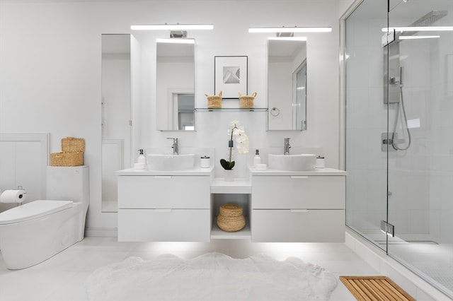 bathroom with tile patterned flooring, vanity, toilet, and a shower with door