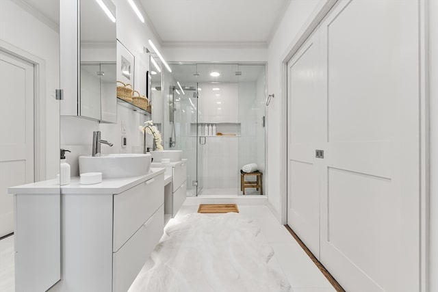 bathroom featuring ornamental molding, an enclosed shower, and vanity