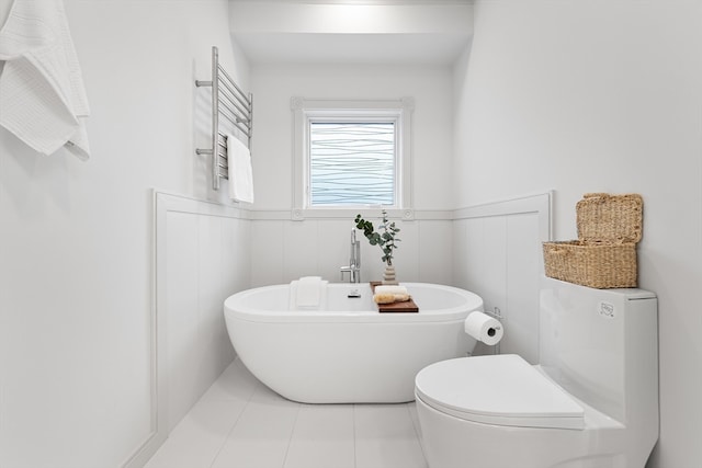 bathroom featuring a tub, tile patterned floors, and toilet