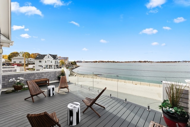 deck with a water view and a view of the beach