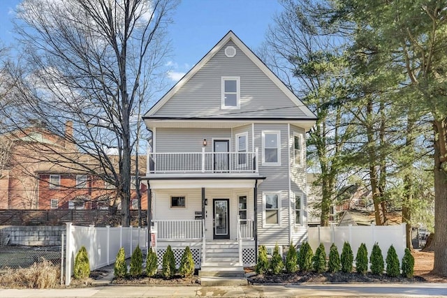 view of front property featuring a balcony and a porch