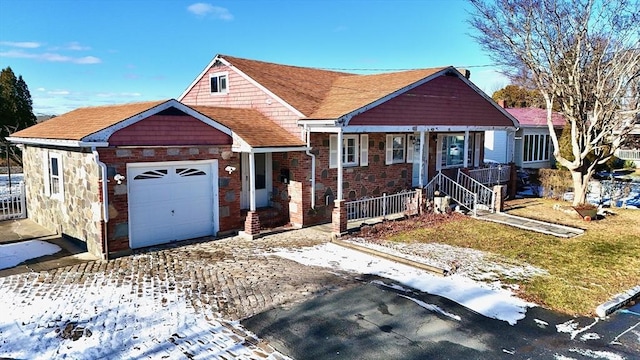 view of front facade with a garage and a porch