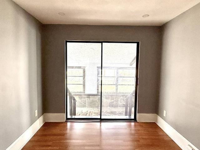 empty room featuring dark hardwood / wood-style flooring