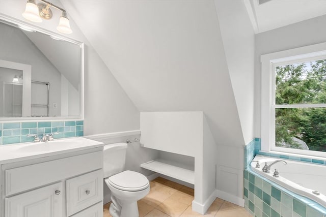 bathroom with tile patterned floors, a relaxing tiled tub, vanity, and a healthy amount of sunlight