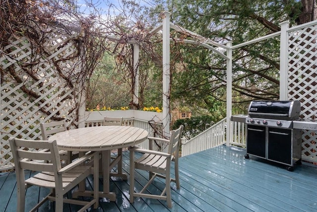 wooden deck with a grill and outdoor dining area