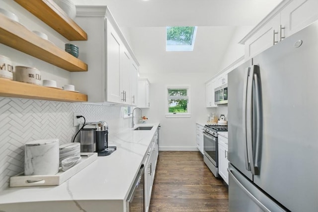14 Turning Mill Ln Unit 14, Quincy, MA 02169 - kitchen featuring appliances with stainless steel finishes, a skylight, dark wood-style floors, tasteful backsplash, and open shelves