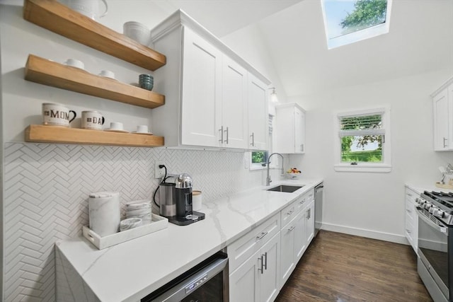 14 Turning Mill Ln Unit 14, Quincy, MA 02169 - kitchen with stainless steel appliances, a skylight, backsplash, light stone countertops, and white cabinets