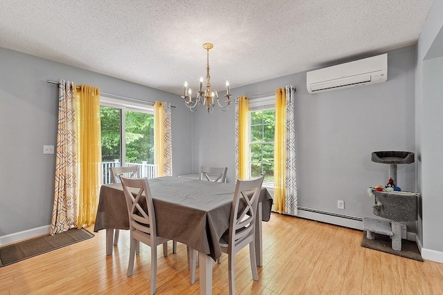24 Joel Scott Dr, Holden, MA 01520 - dining area featuring a wall mounted air conditioner, a chandelier, light wood-style floors, plenty of natural light, and a textured ceiling