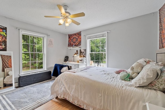24 Joel Scott Dr, Holden, MA 01520 - bedroom with wood finished floors, a textured ceiling, and a ceiling fan