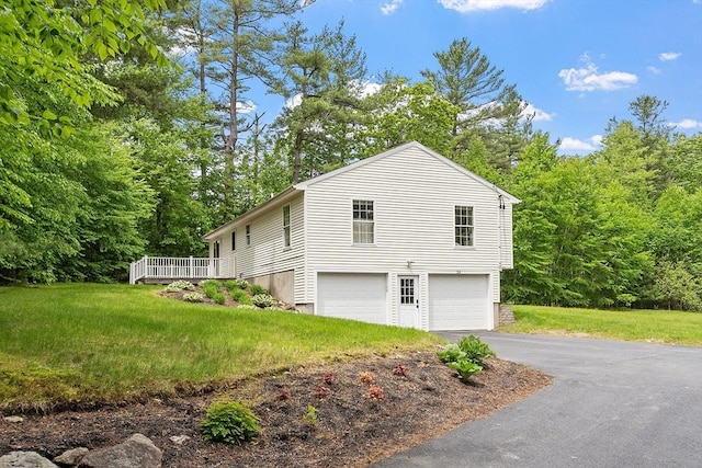 24 Joel Scott Dr, Holden, MA 01520 - view of side of property with an attached garage, asphalt driveway, a wooden deck, and a yard
