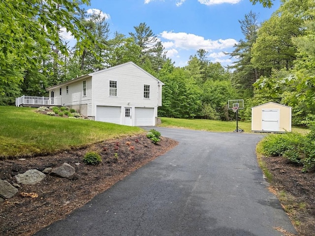 24 Joel Scott Dr, Holden, MA 01520 - view of side of property featuring an attached garage, a lawn, asphalt driveway, and a deck