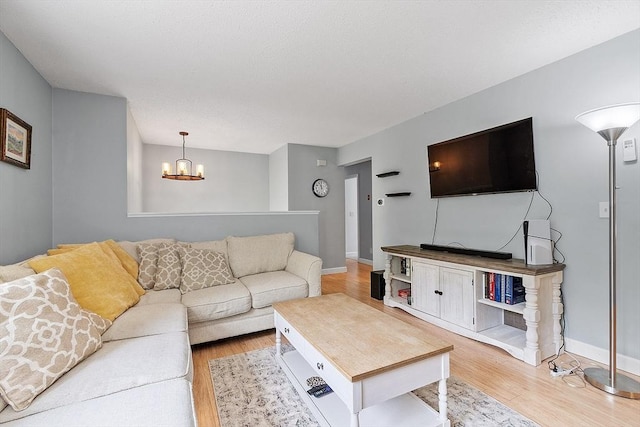 24 Joel Scott Dr, Holden, MA 01520 - living room with a chandelier, light wood-style flooring, and baseboards