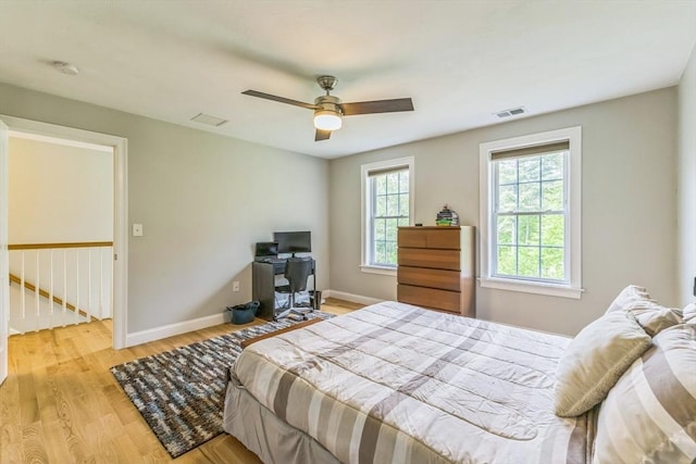 82 Sutton St, Uxbridge, MA 01569 - bedroom with light wood-type flooring, multiple windows, baseboards, and a ceiling fan