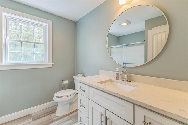 82 Sutton St, Uxbridge, MA 01569 - full bathroom with a stall shower, vanity, toilet, baseboards, and wood finished floors
