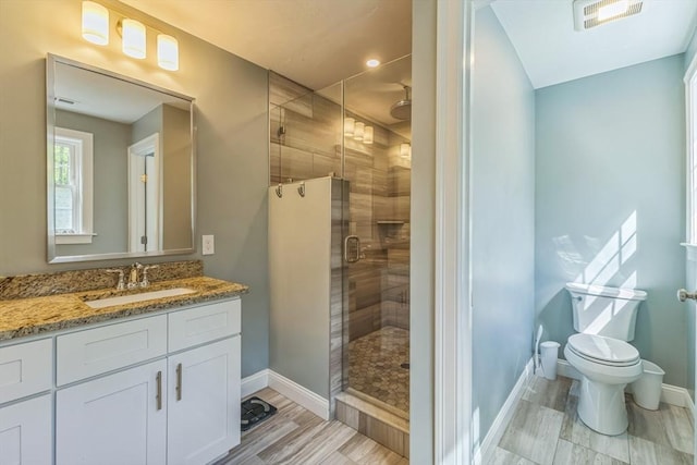82 Sutton St, Uxbridge, MA 01569 - bathroom featuring a shower stall, baseboards, vanity, toilet, and wood finished floors